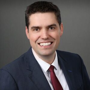 professional headshot of Billy Doherty smiling at the camera.