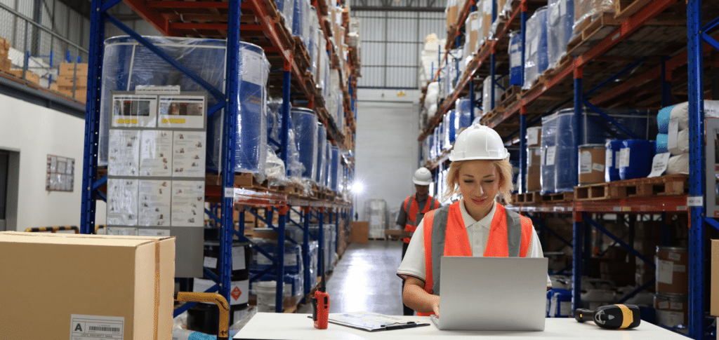 woman working on laptop in warehouse